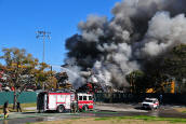 Cars, plastic, fiberglass, oil, and fuel burned for hours. Smoke was visible across several counties.